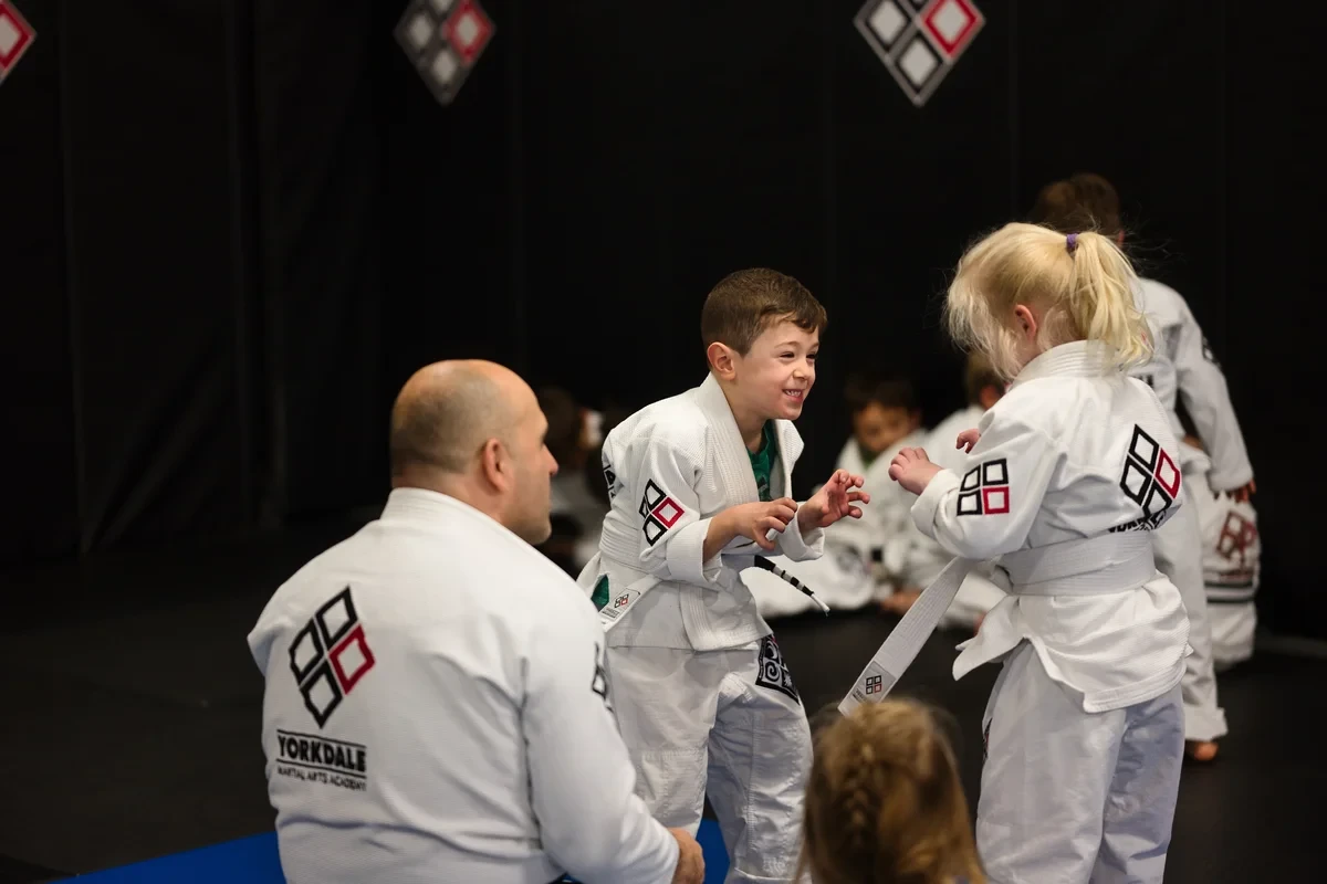 Kids practicing Brazilian Jiu Jitsu techniques near Toronto at Yorkdale Martial Arts Academy - children learning grappling skills