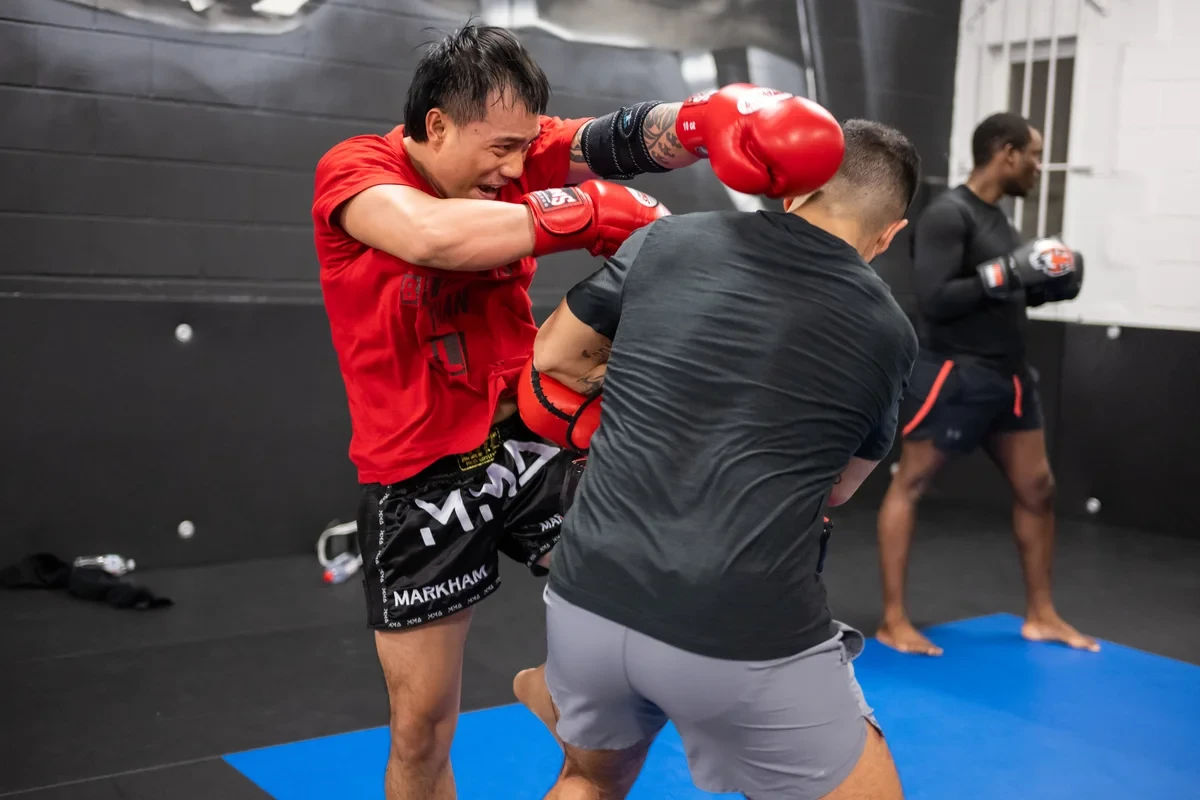 Muay Thai sparring with knee strikes at Yorkdale Martial Arts Academy in York