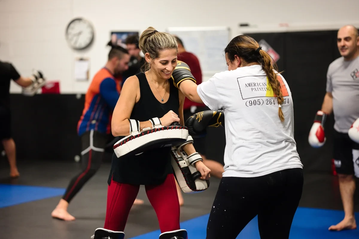 Women training Muay Thai pad work at Yorkdale Martial Arts Academy serving Toronto - focus mitt drills for kickboxing fitness